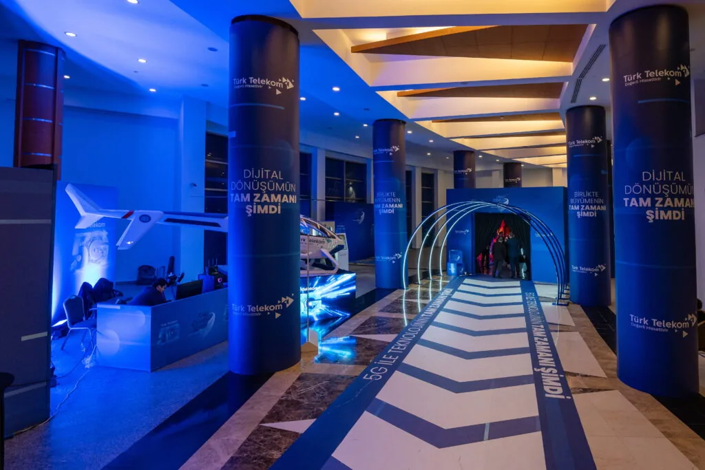 Blue branded corridor with wrapped columns and LED arches at the Türk Telekom Business Partners Meeting, Rixos Sungate, Antalya