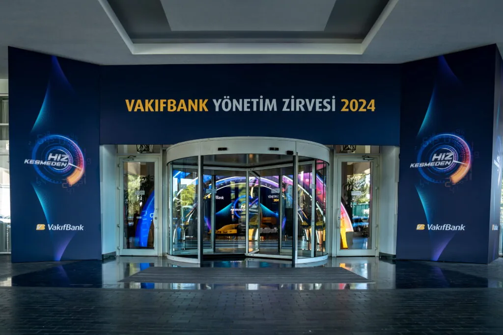 Hotel entrance dressed with campaign branding for the VakıfBank Management Summit 2024 at Titanic Deluxe Golf Belek, Antalya