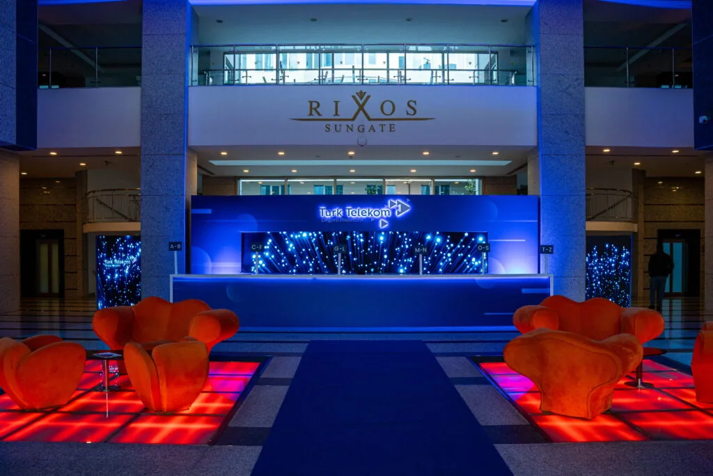 LED-fronted registration desk with lounge seating in the lobby of Rixos Sungate, Kemer, Antalya