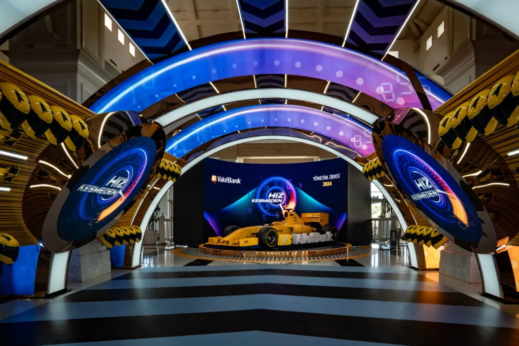 LED tunnel entrance with illuminated arches and a race-car display at the VakıfBank Management Summit at Titanic Deluxe Golf Belek, Antalya
