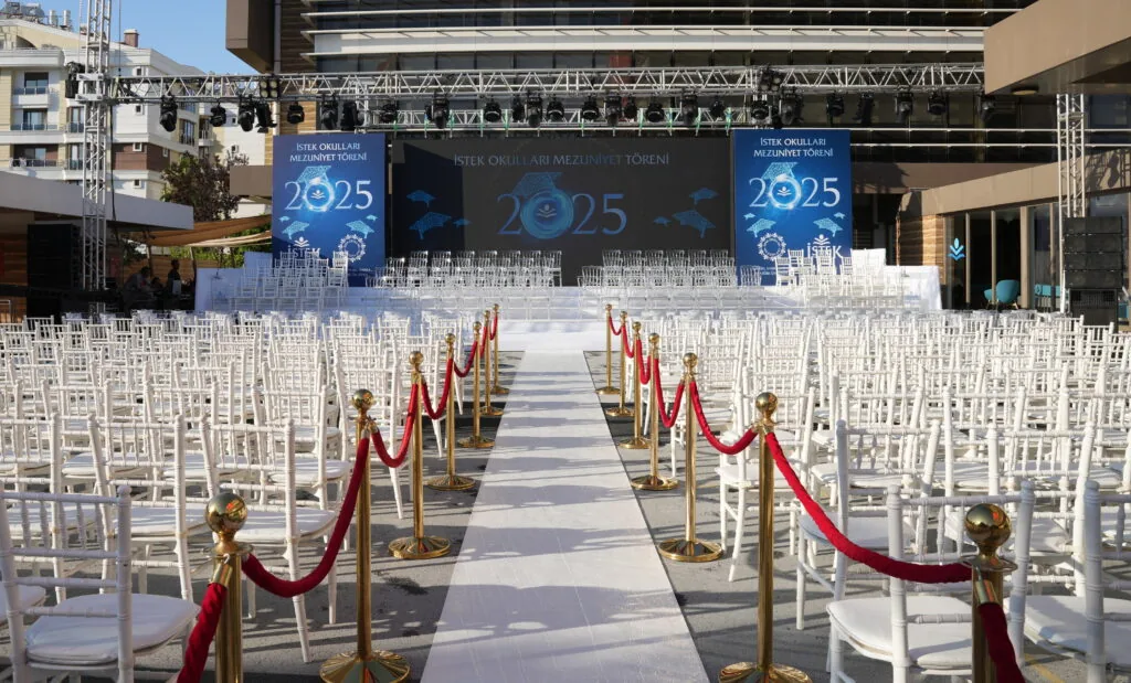 Open-air graduation ceremony stage with truss, LED screens and red-carpet aisle for İSTEK Schools in Antalya