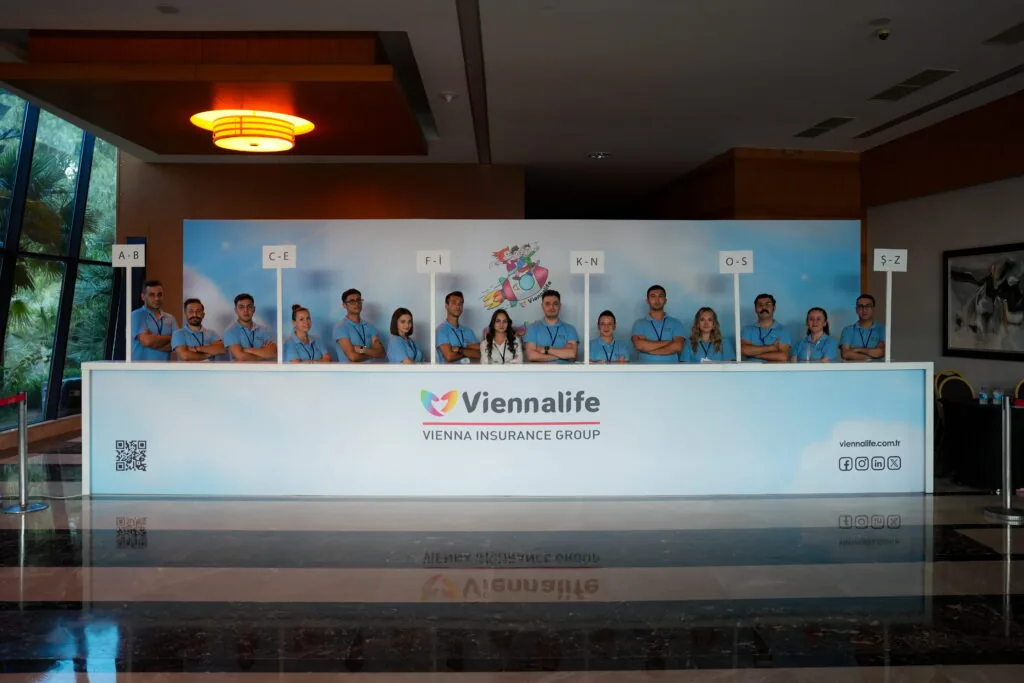 Branded registration counter with event staff for a Viennalife corporate event, Türkiye